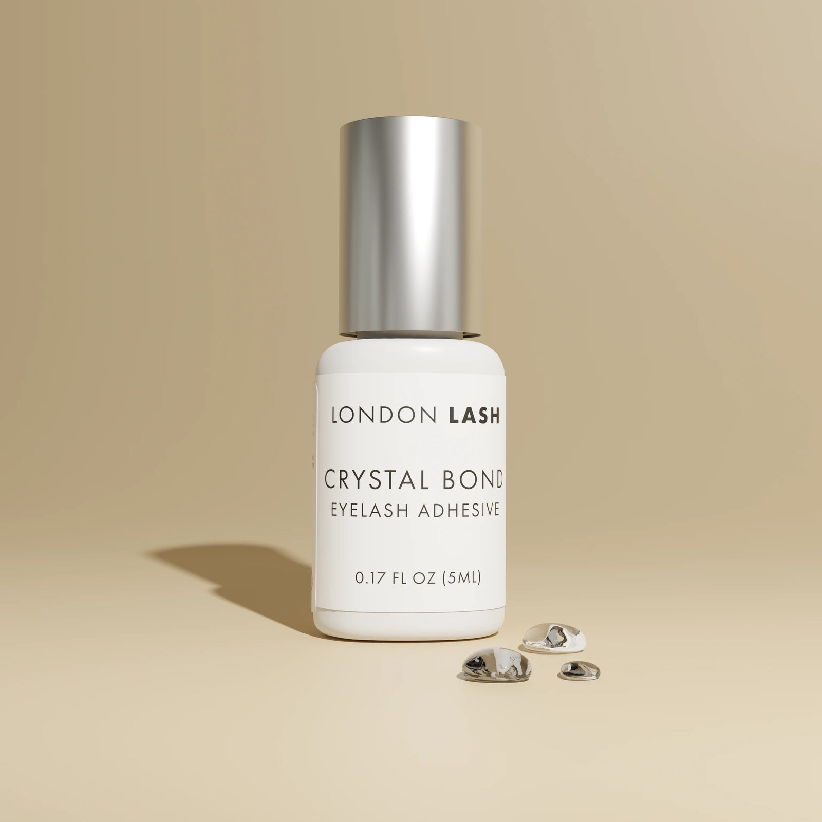 London Lash Glue Subscription - Crystal Bond Eyelash Adhesive bottle on beige background
